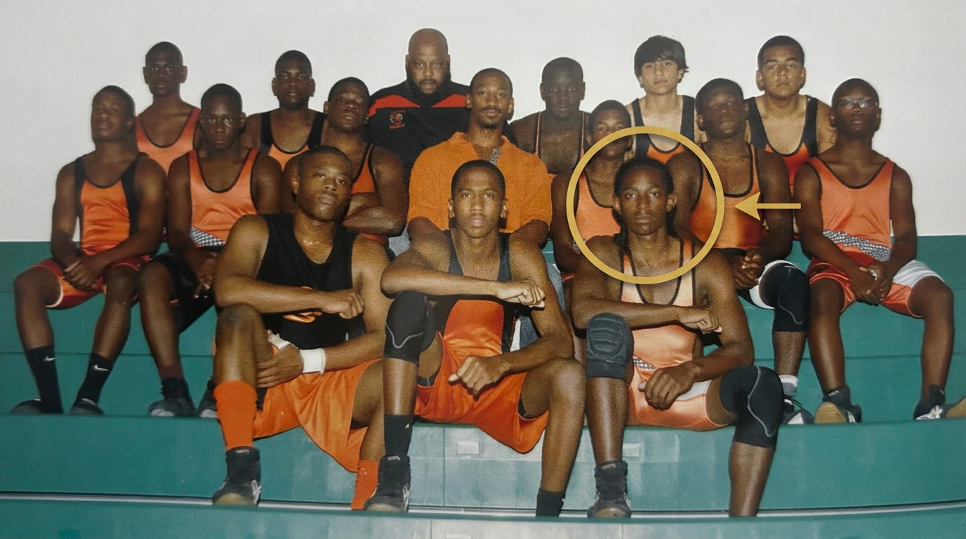 Taurus Anderson with braids, highlighted in his high school wrestling team photo